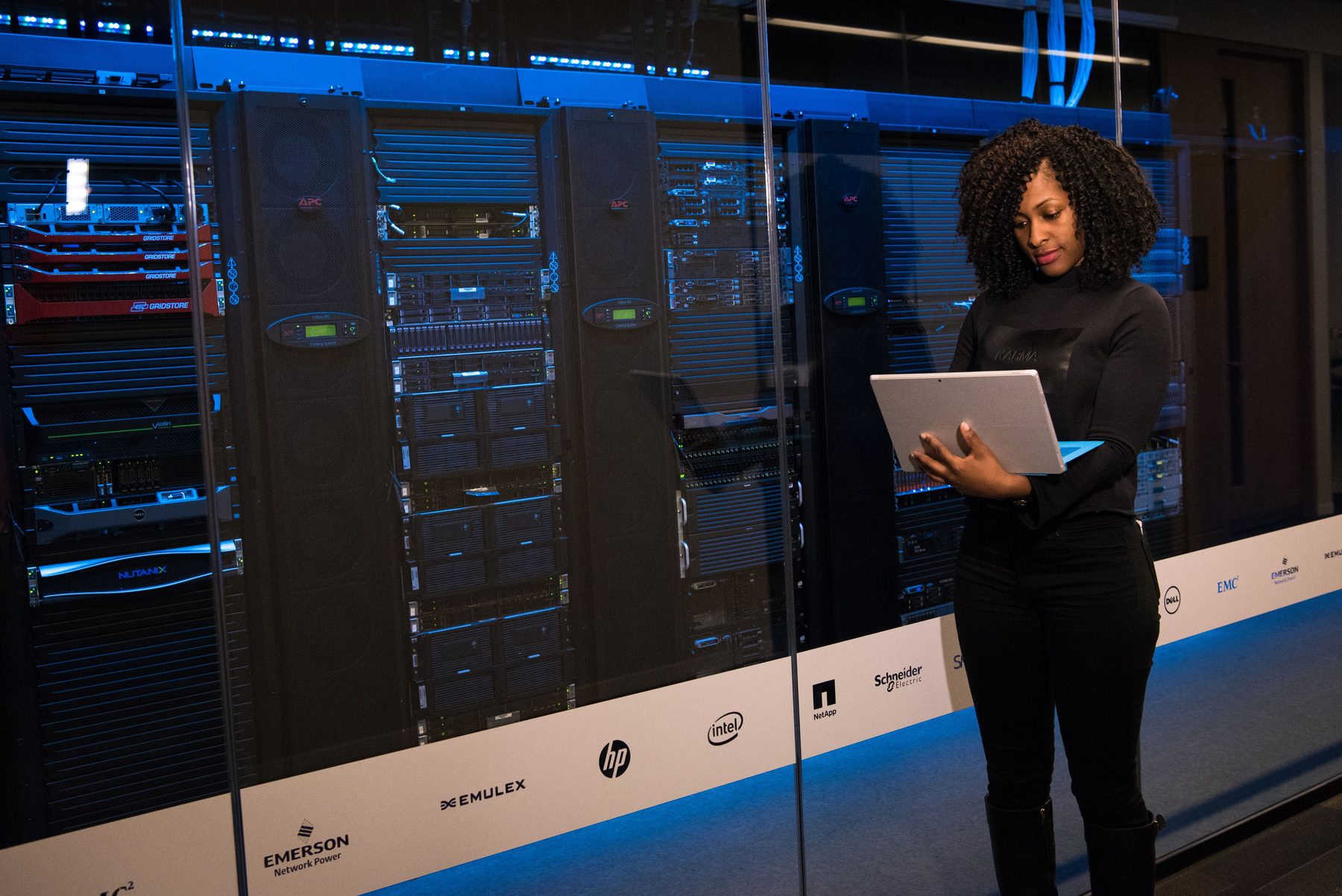 An engineer working beside server racks in a data centre